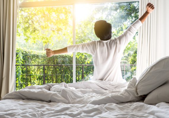 Man waking up in bed