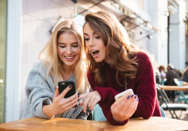 Two girls talking excitedly