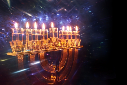 praying at the chanukah candles