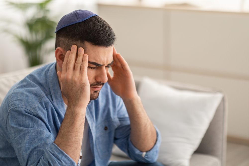 How does my suffering in this world atone for my deceased parent?