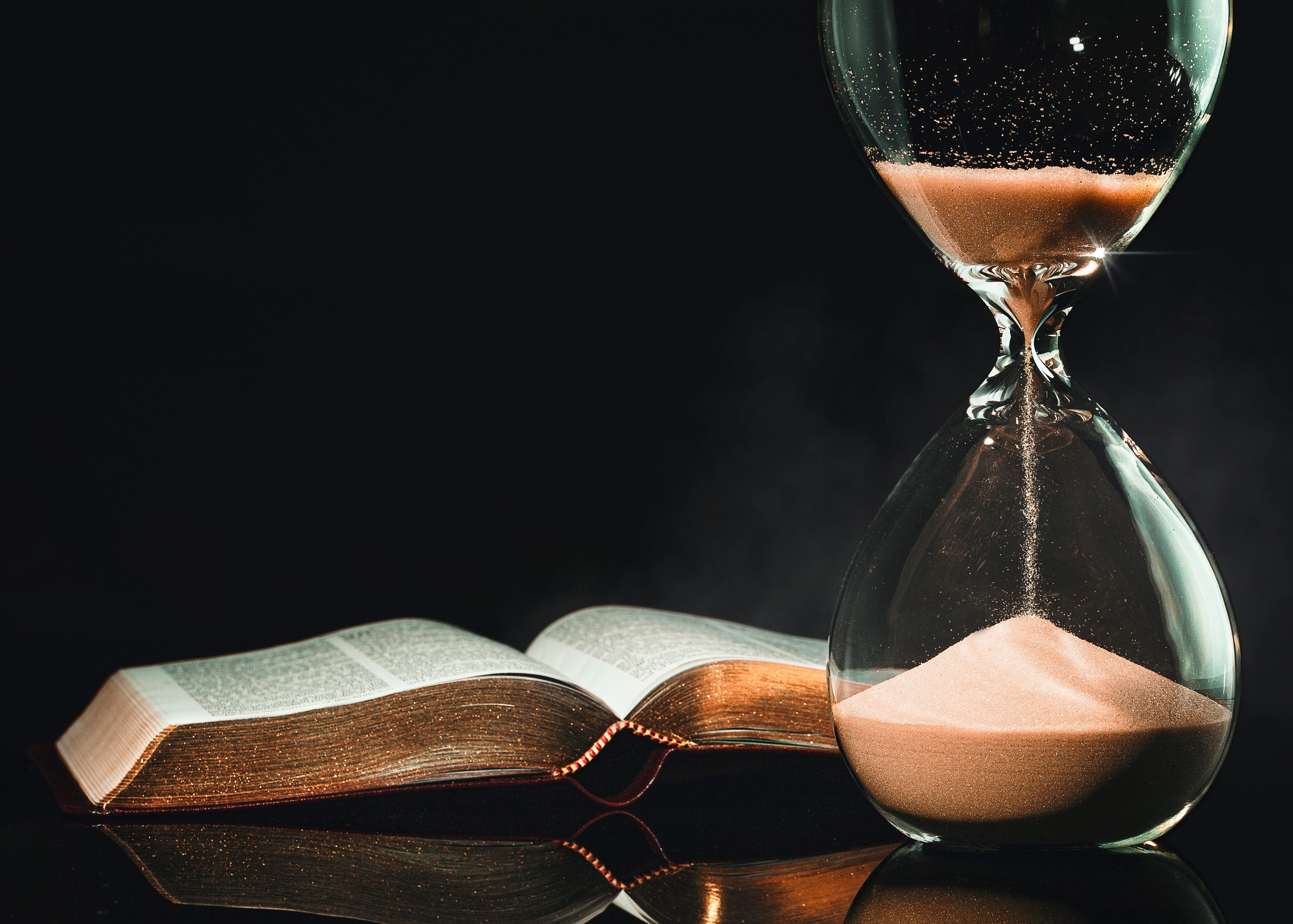 torah book next to an hourglass