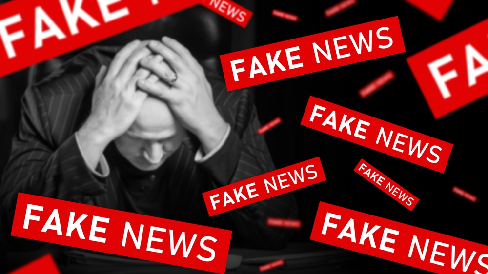 man being bombarded with fake news