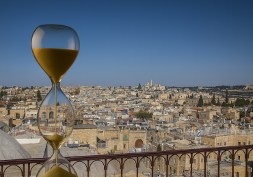 Hourglass over Jerusalem skyline symbolizing the countdown to redemption.