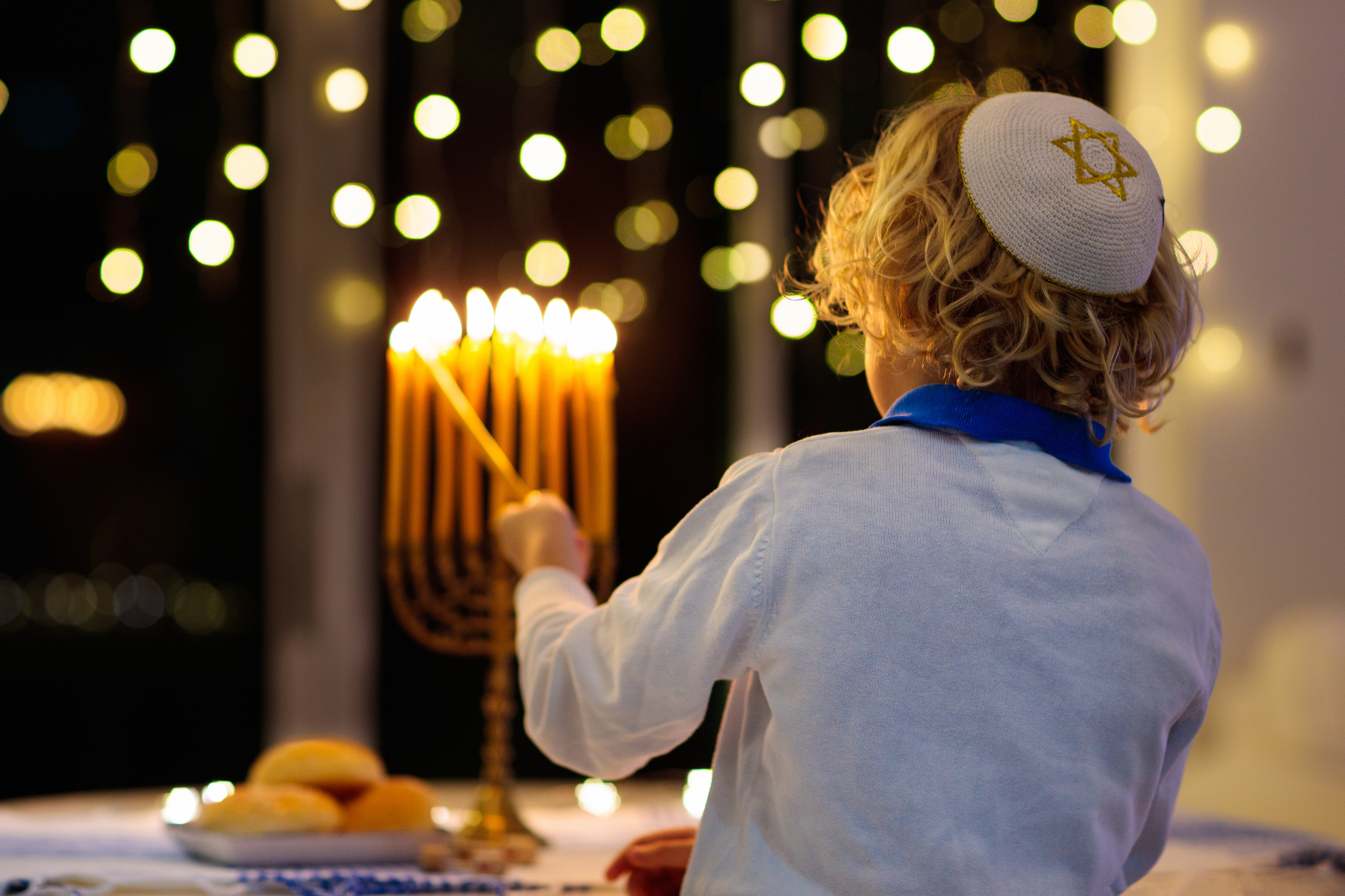 Child lighting a menorah