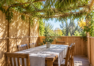 A simple wooden table beneath the leafy schach of a peaceful sukkah.